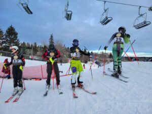 Group of men lined up at the start ramp, ready to race down the hill at Snow Valley’s Masters Racing Program in Edmonton.