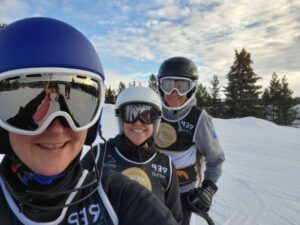 Selfie of three women in racing gear waiting at the top of the hill before a race at Snow Valley’s Masters Racing Program in Edmonton.